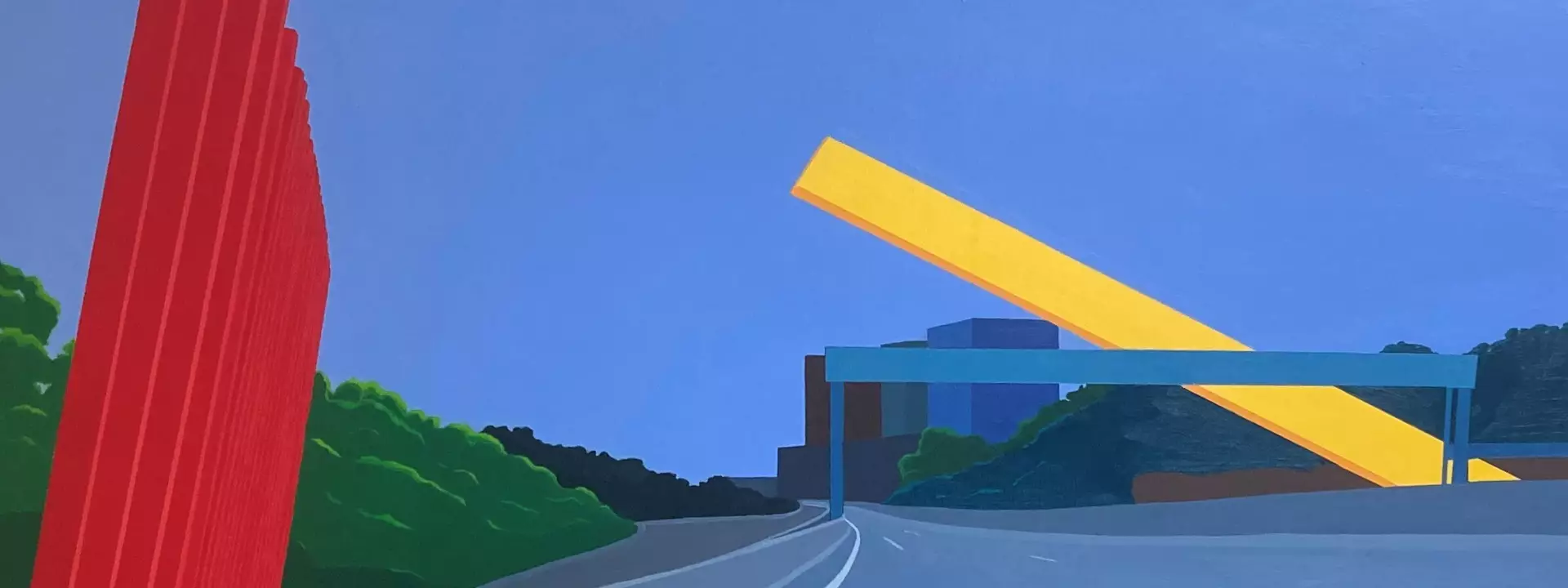 Red and yellow diagonal structures next to grey freeway and blue sky