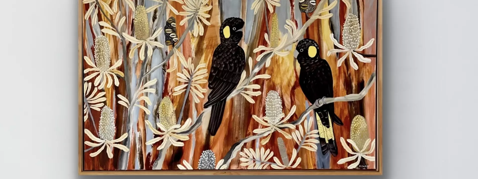 A pair of black cockatoos in an Australian banksia setting