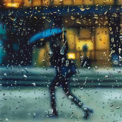 Umbrella person through rain covered window.