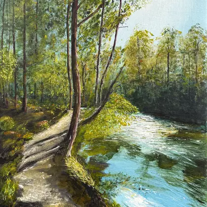 The sun shines brightly through an Australian forest. A path runs along the river in dappled light into the distance. In the…