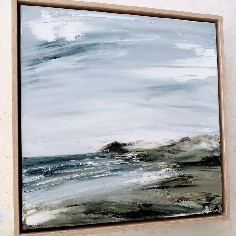 Overcast moody sky over ocean and rugged Australian coastline — artist's signature