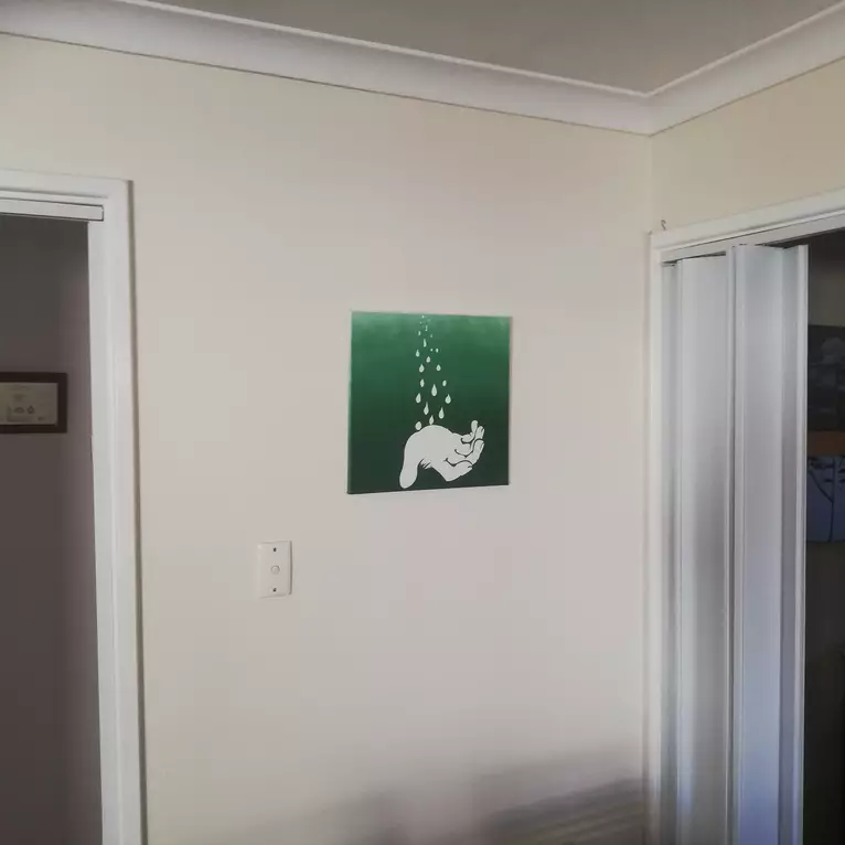 White Magical Hand on a Green Field — shown hanging