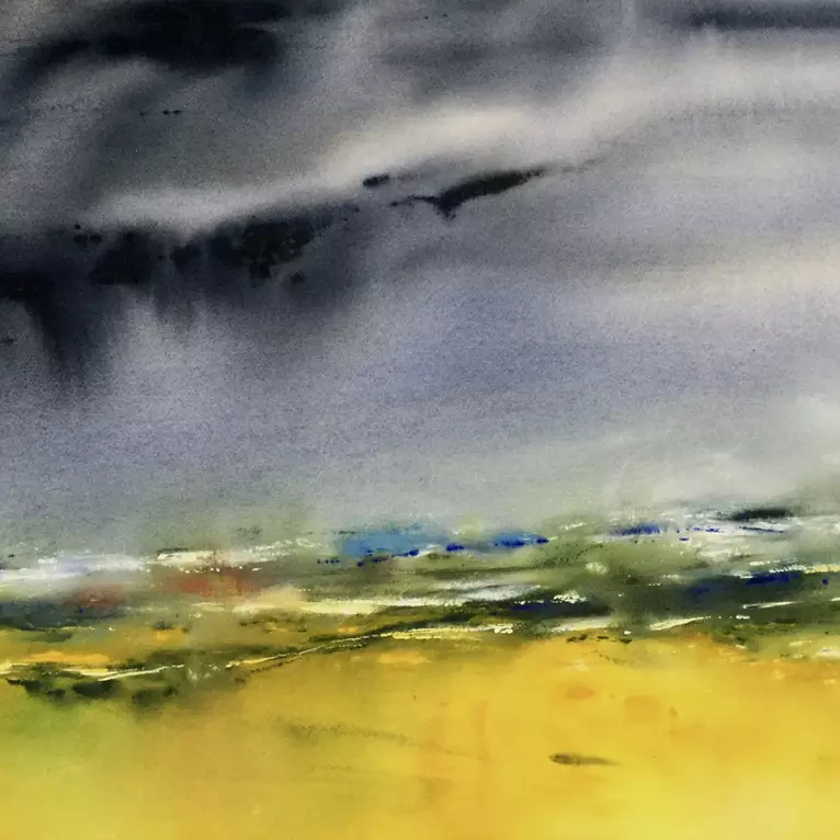 Stormy dark skies soon to cool a still warm earth of vivid gold.