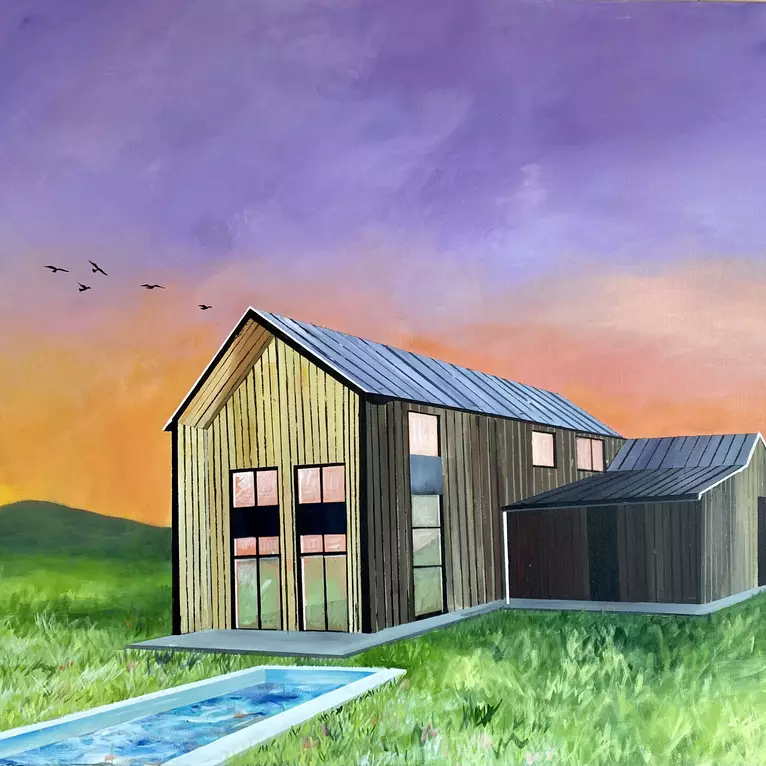 A barn style building set on a field with a pool against a vibrant sky of purple and orange