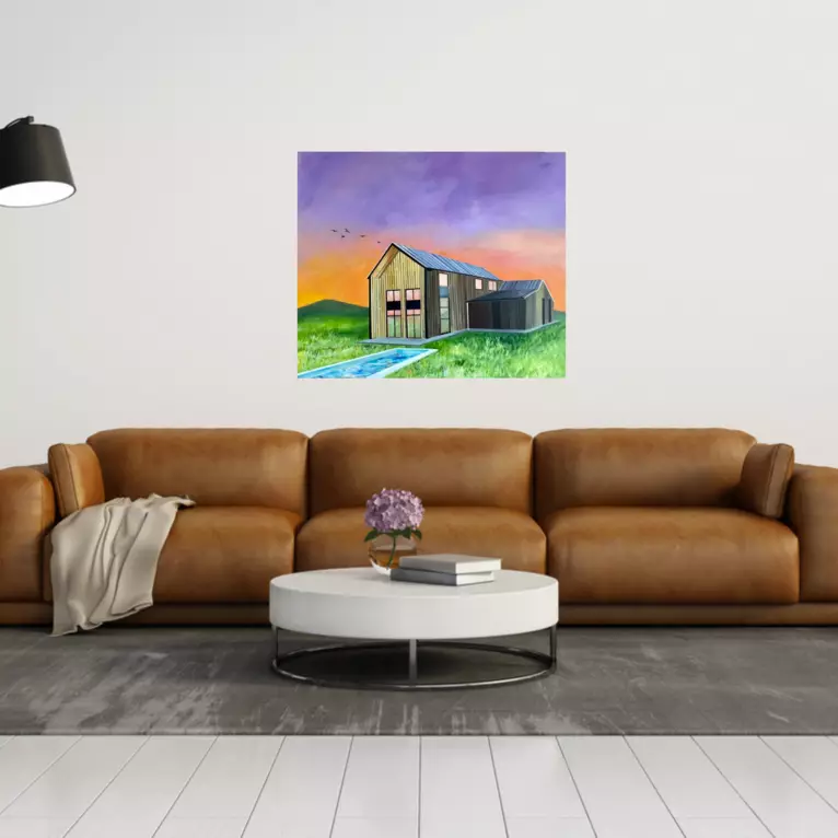 A barn style building set on a field with a pool against a vibrant sky of purple and orange — shown in a room setting
