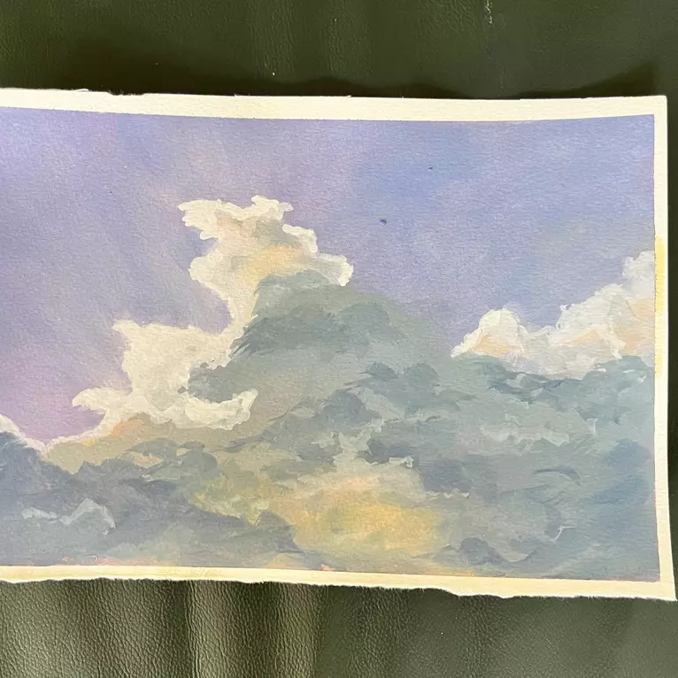 Sunlight coming through clouds, in blue and grey and yellow — edge view