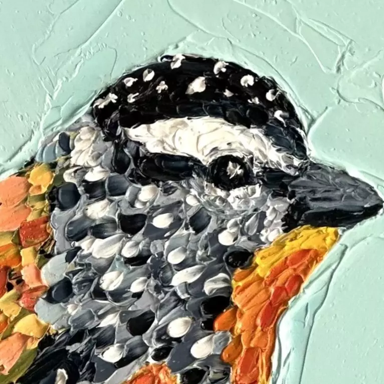 Small painting of an Australian Spotted Pardalote bird painted in textured oil paints. — edge view