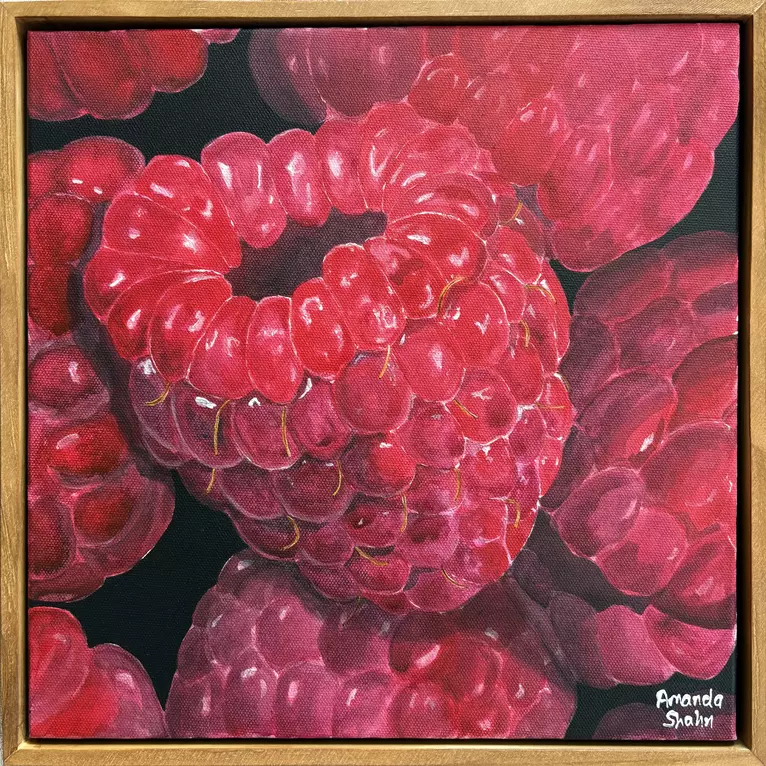 A bunch of raspberries on a black background