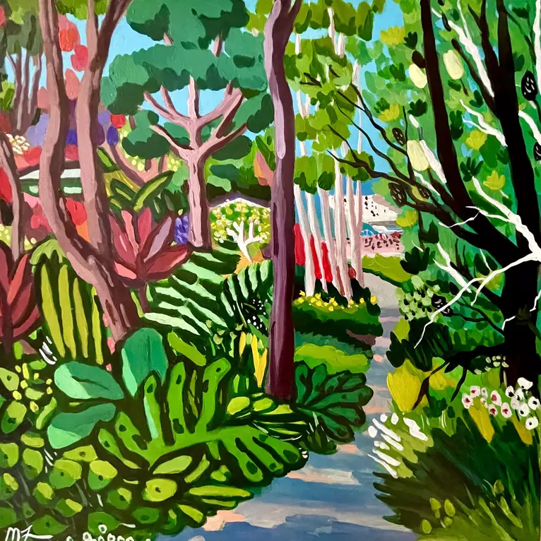 A bush track leading to Clovelly beach. On both sides of the of the track is gardens and natural bush. The sun is coming thr…