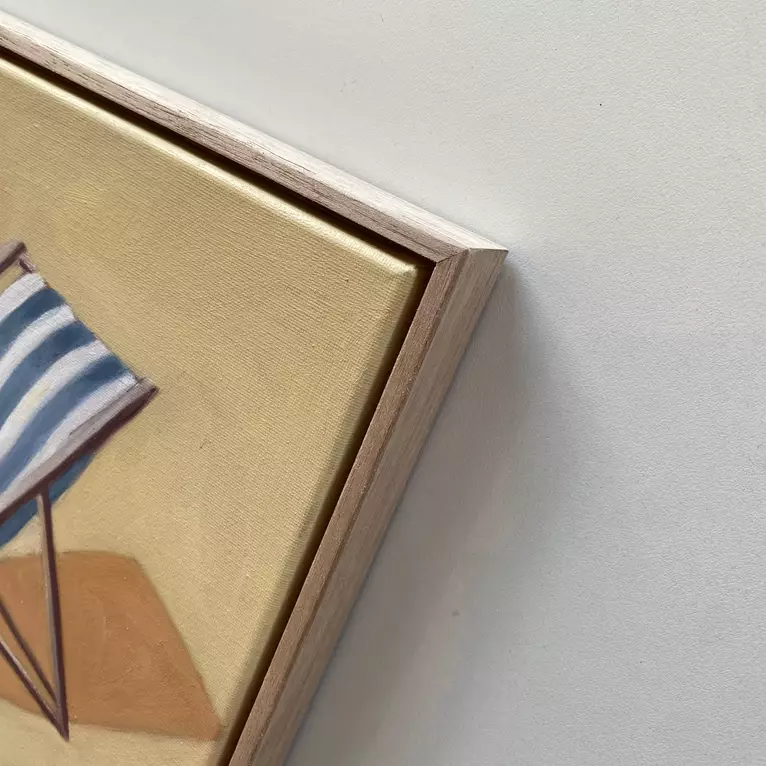 a blue and white striped deck chair in a yellow background — edge view