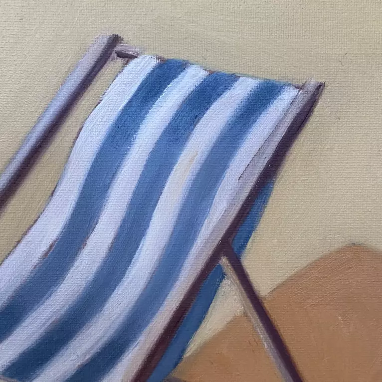 a blue and white striped deck chair in a yellow background — detail