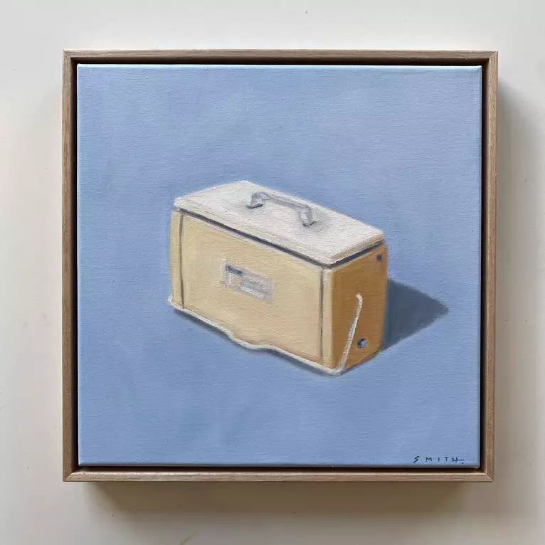 a yellow cooler with shadow on a blue background — shown hanging