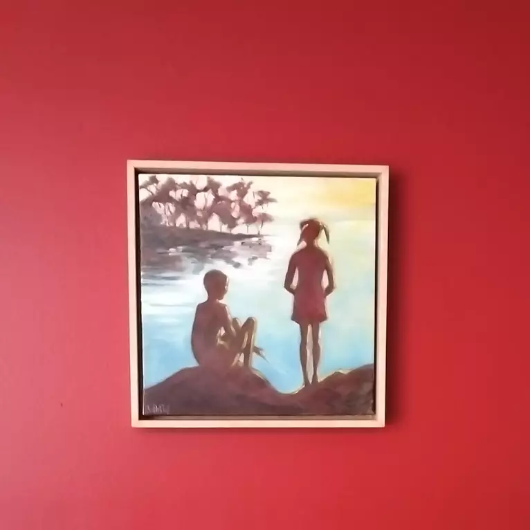 Two young people are silhouetted on a quiet lake Edge. — shown hanging
