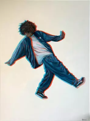 Man in blue tracksuit dances on cream background