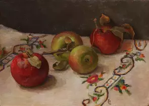 four apples and their foliage against a coloured tablecloth and dark background