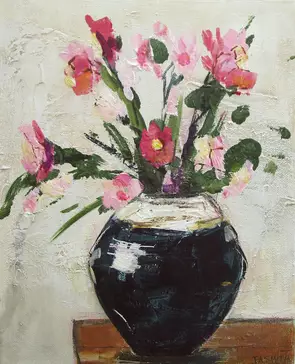 pink and red flowers in a shiny, blue, ceramic vase against a wall of textured white plaster