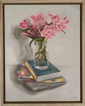 flowers in glass bottle on book, cloth.
