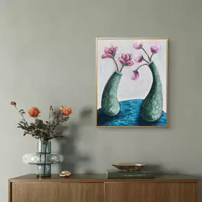 Two green vases curving towards each other with pink flowers in them.