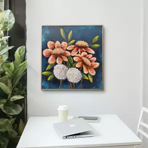 Three flowers that are pink, peach and orange in colour and also two white pom pom flowers on a dark blue background.