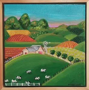 A little cow shed sitting in a lush green idyllic setting beneath high mountains , cows grazing in the foreground in Bonnie …