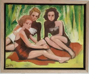 Three young women wearing swimmers sit on an orange towel on the ground with trees in the background.