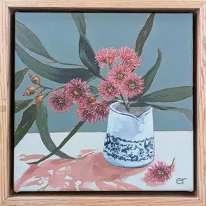 Pink flowering gums and unkempt gum leaves in a little blue and white vintage ceramic jug with a grey green background