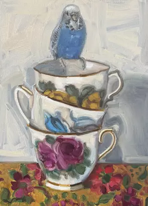 Blue budgie sitting on a stack of vintage teacups