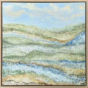 soft rolling hills, meandering creek and rocky outcrops form across a landscape with a vast sky covered in soft floaty cloud…