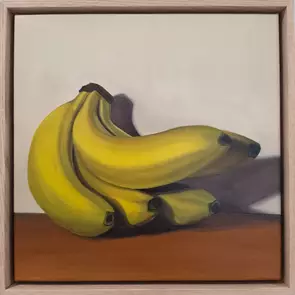 A contemporary realistic oil painting depicting ripe yellow bananas arranged in a simple still-life composition. Warm, direc…