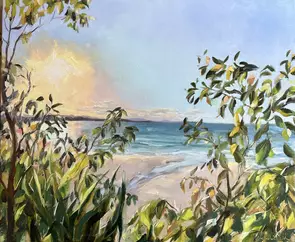 Sun setting over little cove. Sun is setting in the distance over the ocean with a little estuary feeding into the beach. Ba…