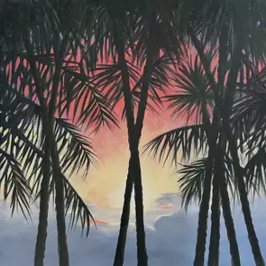 Tall palm trees are silhoutted against a fiery sunset.