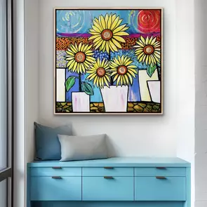 A modern white garden pot display of yellow sunflowers