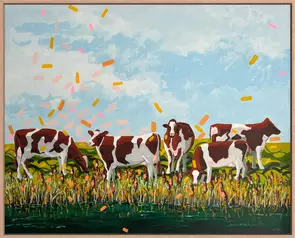 A small herd of Hereford cows graze contentedly by a stream.