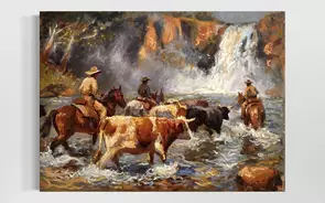 Stockman on horseback are leading cattle into beautiful moving waters to cool off on a hot day. A rumbling waterfall is crea…