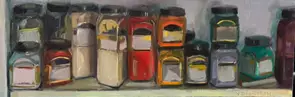 A shelf of acrylic paint pots in an artist's studio.