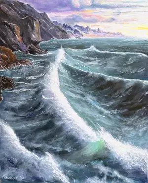 Large waves crash on a rocky shore with towering mountains in the distance
