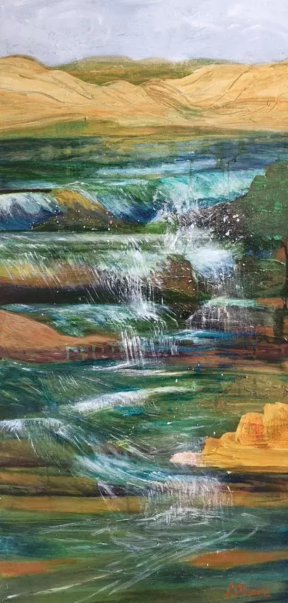Cascading water, through rocks and sand, could be a river or the sea.