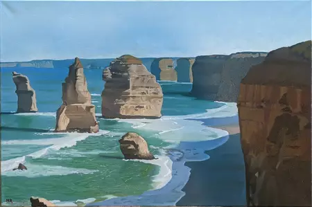 The Twelve Apostles rock formation towers over the turquoise ocean, with crashing waves creating white foam on the beach.