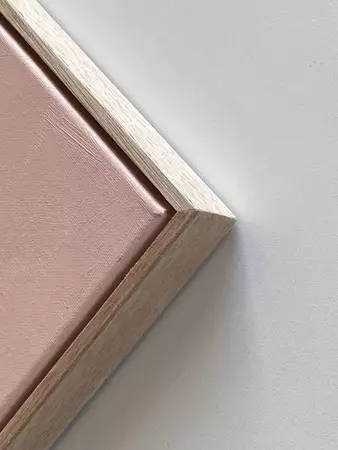 a portable three-legged barbecue on pink background — edge view